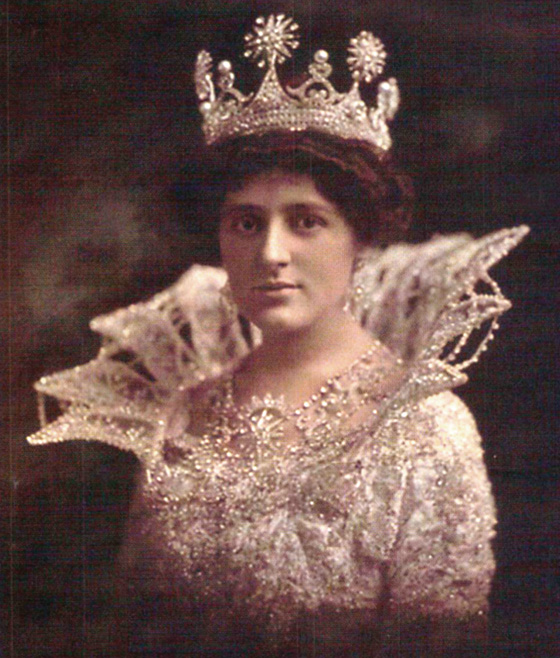 Queen of Proteus in 1912, Corinne McCloskey wears a delicate Medici-style collar with her white lace dress and crown jewels.