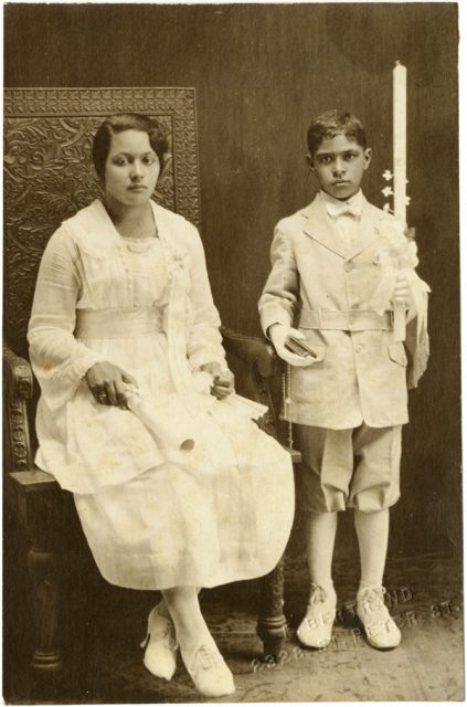 Portrait of a young woman and boy dressed in white