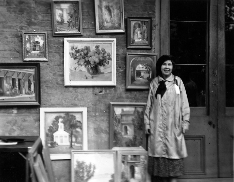 Alberta Kinsey with her paintings on exhibit at Pirate’s Alley, in New Orleans.