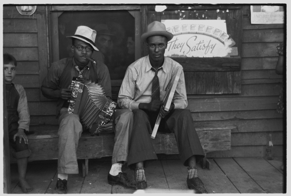 Negro musicians playing accordion and washboard in front of store, near New Iberia, Louisiana