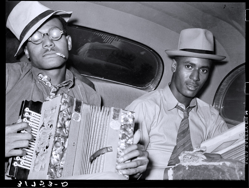 “Negro musicians playing accordion and washboard in automobile. Near New Iberia, Louisiana”