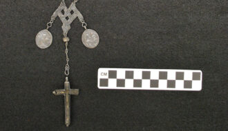 Medallion and crucifix recovered from archaeological excavations at St. Peter Street Cemetery.